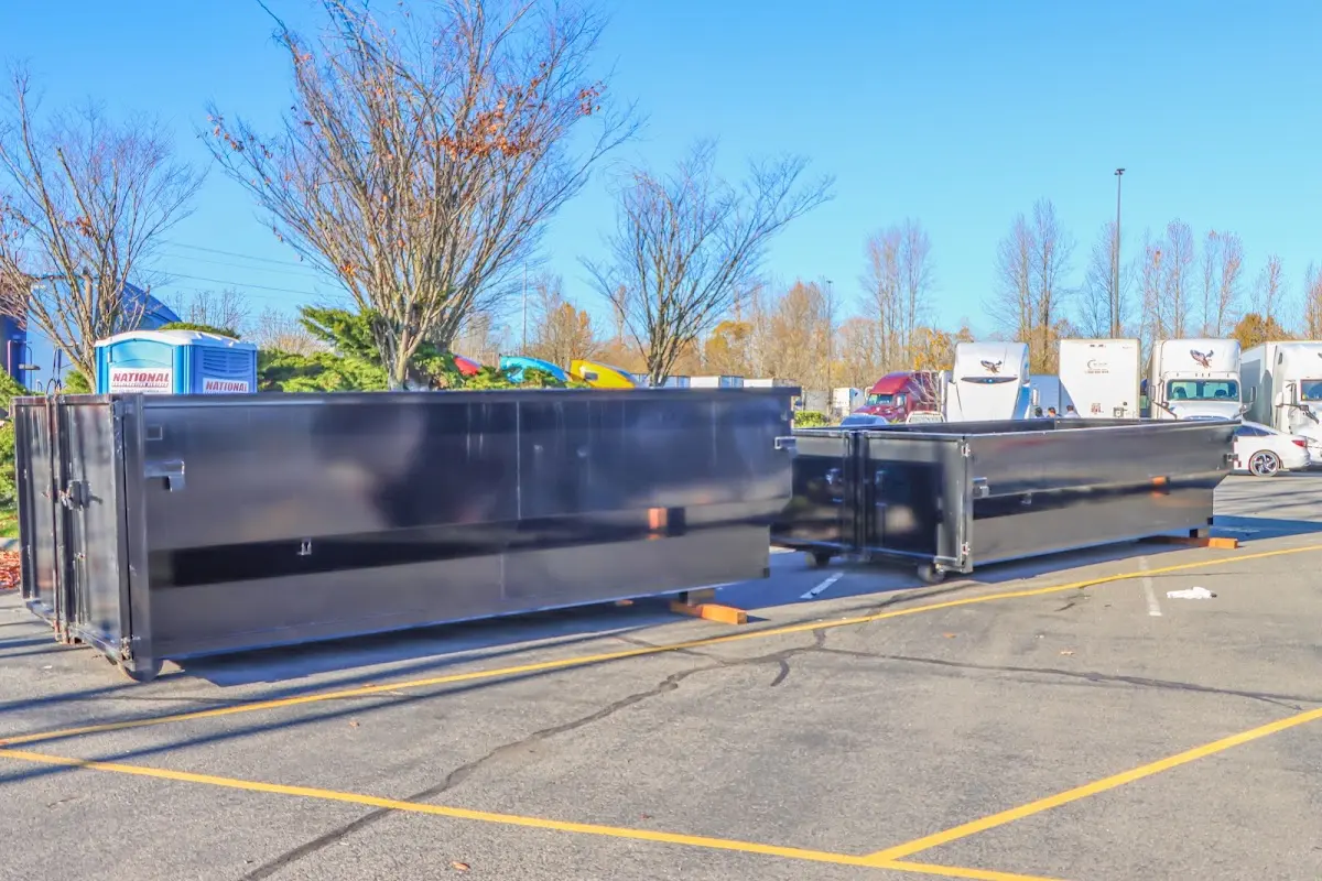 Professional dumpster rental service with roll-off container on residential driveway in Westland